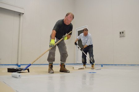 workers applying proxy flooring